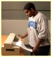 student using the braille printer